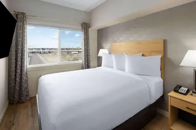 a bedroom with a large bed and a window at Baymont by Wyndham West Edmonton in Edmonton