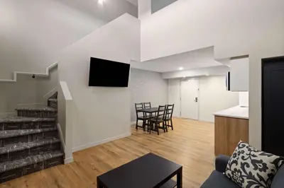 a living room with a couch and a table at Baymont by Wyndham West Edmonton in Edmonton
