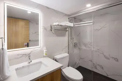 a bathroom with a toilet and a sink and a shower at Baymont by Wyndham West Edmonton in Edmonton