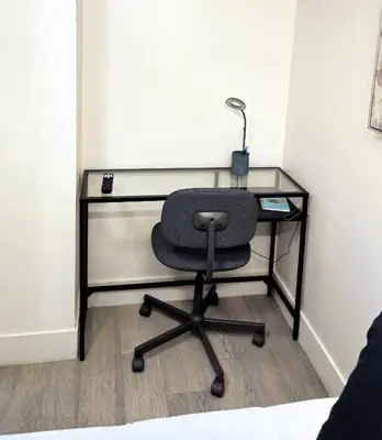 a desk with a chair and a lamp on it at Cozy Retreat in Mission City