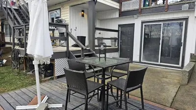 a patio with a table and chairs on a deck at Cozy Retreat in Mission City