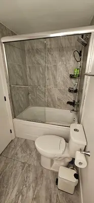 a bathroom with a toilet and a bath tub at Cozy Retreat in Mission City