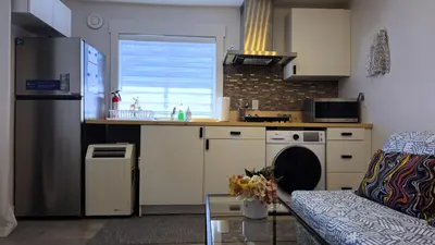 a kitchen with a sink and a dishwasher at Cozy Retreat in Mission City