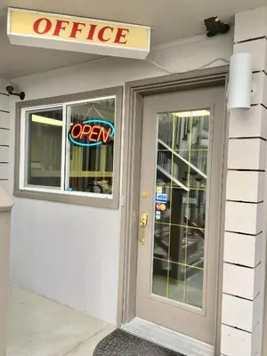 a entrance to an office with a sign on the door at Canterbury Inn in Invermere