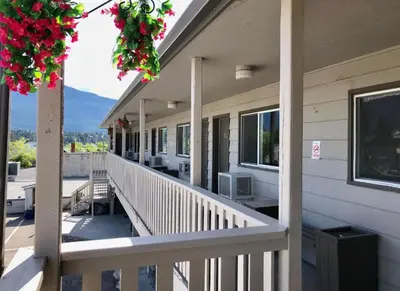 a balcony of a house with a view of the mountains at Canterbury Inn in Invermere