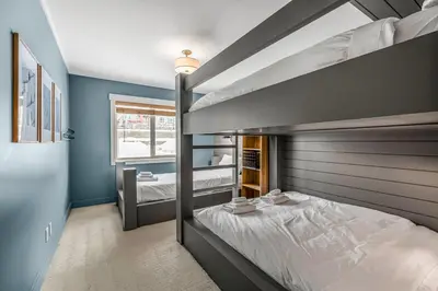 a bedroom with a bunk bed in a room at Vista at Big White w Amazing Location and View in Big White