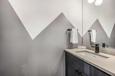 a bathroom with a sink and a mirror at Vista at Big White w Amazing Location and View in Big White