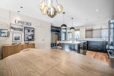 a kitchen with a large wooden table in a room at Vista at Big White w Amazing Location and View in Big White
