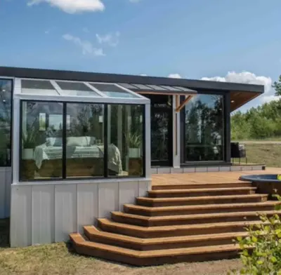 a house with glass doors and wooden stairs at Refuge Bay Caelum Cabin Luxury Off Grid Escape in Cherhill