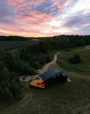 a house with solar panels on it in a field at Refuge Bay Caelum Cabin Luxury Off Grid Escape in Cherhill