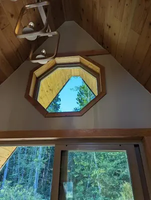 a window in the ceiling of a tiny house at Tree Ring Cabin on 33 Acre Farm in Powell River