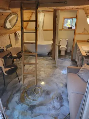 a bathroom with a bath tub in the middle of the floor at Tree Ring Cabin on 33 Acre Farm in Powell River