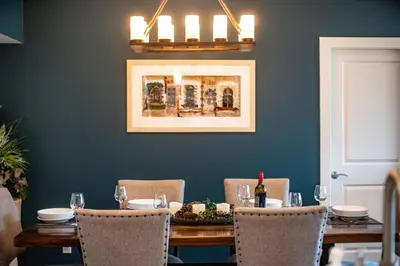 a dining room with a table with chairs and a painting at Downunder Mountain Retreat in Revelstoke