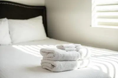 a pile of towels sitting on top of a bed at Downunder Mountain Retreat in Revelstoke