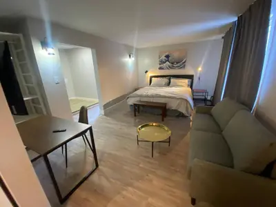 a living room with a bed and a couch at Newly Renovated 1br1ba With Asian Style Tea Room in Edmonton