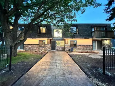a brick building with a tree in front of it at Newly Renovated 1br1ba With Asian Style Tea Room in Edmonton