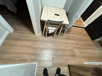 a dining room table with chairs and a wooden floor at Guest Suite Close To Whtye Ave in Edmonton