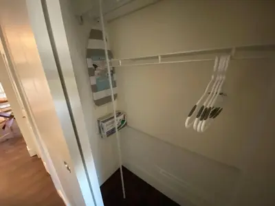 a room with a wall with a shelf with utensils at New Dt Apartment Walk To All in Edmonton