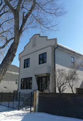 a white building with a tree in front of it at New Dt Apartment Walk To All in Edmonton