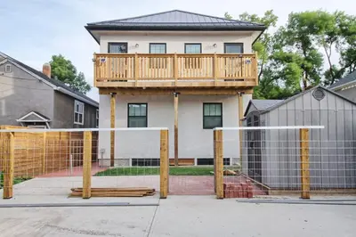 a house with a deck on top of a volleyball net at New Dt Apartment Walk To All in Edmonton