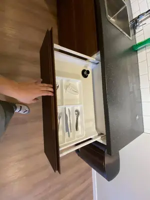 a person opening the door of an empty refrigerator at Close To Whyte University New Renovation in Edmonton