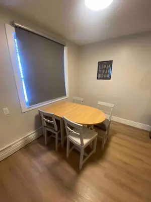 a classroom with a table and chairs and a large window at Morden Newly Renovated 1br Flats, Walk To Whyte in Edmonton