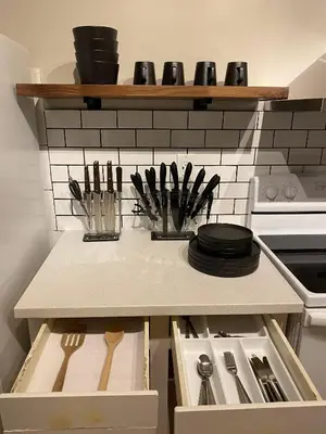 a kitchen with a counter with plates and utensils at Morden Newly Renovated 1br Flats, Walk To Whyte in Edmonton