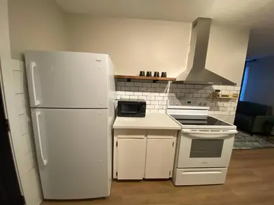 a kitchen with a white refrigerator and a stove at Morden Newly Renovated 1br Flats, Walk To Whyte in Edmonton