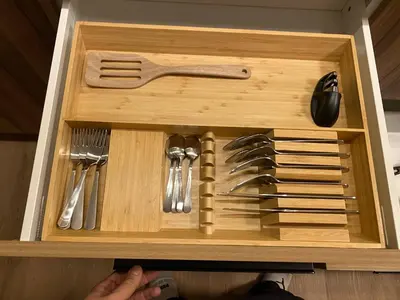 a wooden drawer with utensils in a wooden box at Central 2br Near Unveristy And Whyte Ave in Edmonton