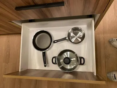two pots and pans on a shelf in a kitchen at Central 2br Near Unveristy And Whyte Ave in Edmonton