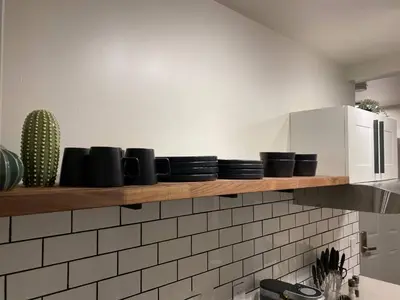 a kitchen with a shelf with cups and a microwave at Central 2br Near Unveristy And Whyte Ave in Edmonton