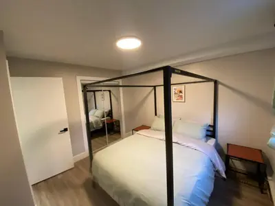 a bedroom with a canopy bed in a room at Brand New Modern Flat 2br1ba Whyte And University in Edmonton