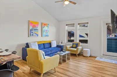 a living room with a blue couch and two chairs at Freshly Remodeled - 2 King Beds- Breathtaking Views in Canmore