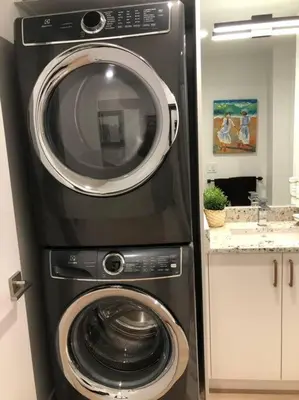 a washing machine and a dryer in a kitchen at Modern luxury and convenience in Marda Loop in Calgary