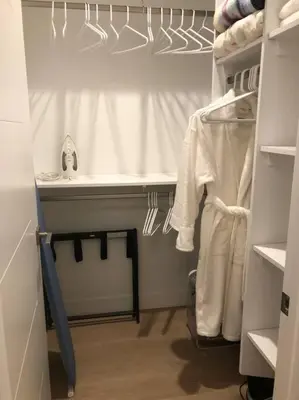 a walk in closet with a white curtain and towels at Modern luxury and convenience in Marda Loop in Calgary