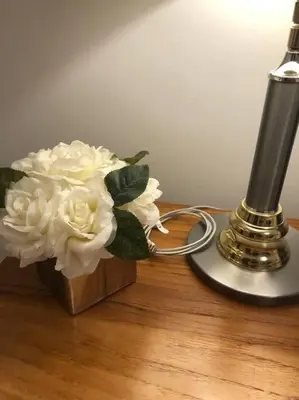 a bunch of white flowers in a box next to a lamp at Modern luxury and convenience in Marda Loop in Calgary