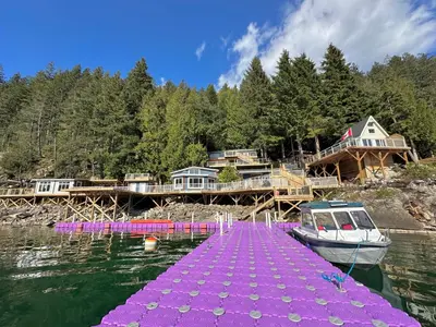 a purple dock with a boat in the water at Private Ozarks Island Retreat in Agassiz