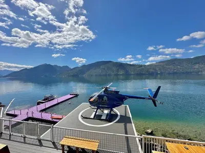 a helicopter sitting on a dock next to a lake at Private Ozarks Island Retreat in Agassiz