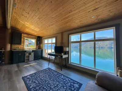 a large living room with a view of a lake at Private Ozarks Island Retreat in Agassiz