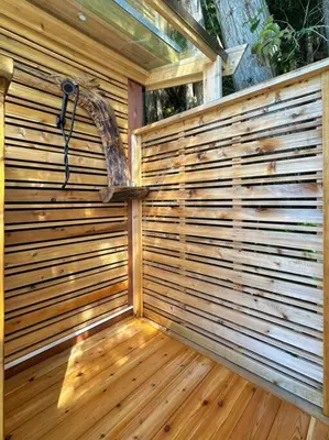 a wooden privacy fence with a shower in a backyard at Private Ozarks Island Retreat in Agassiz