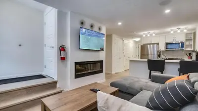 a living room with a couch and a fireplace at Cozy place to stay in south Calgary in Calgary