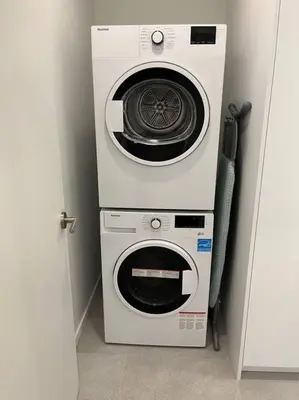 two washing machines are stacked on top of each other at Casa Bramble Luxury 2Bed Suite near UofA Hospital in Edmonton