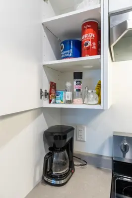 a kitchen counter with a coffee maker in a cupboard at Sunflower Brandnew Cozy Private Suite in Langley