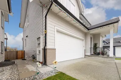 a white house with a white garage door at Sunflower Brandnew Cozy Private Suite in Langley