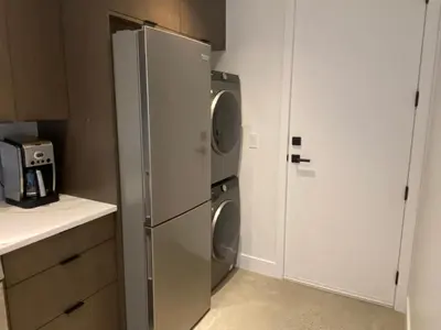 a kitchen with a refrigerator and a washer and dryer at Winchelsea Views in Nanaimo