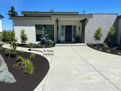 a house with a walkway to a side entrance at Winchelsea Views in Nanaimo