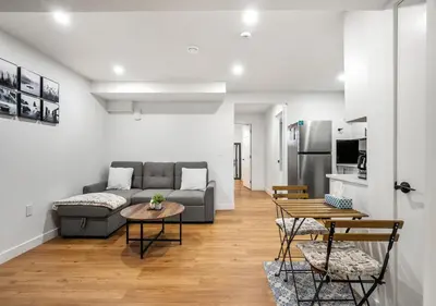 a living room with a couch and a table at Mountain Hideaway Two Bedrooms Free Park Pass in Cochrane