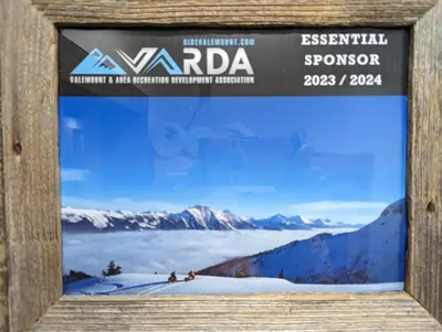 a sign for a ski resort with a picture of a mountain at Skyline Suite 2Bdrm King in Valemount