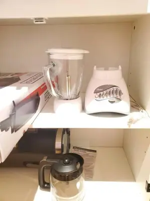 a blender and a food processor on a shelf at Cozy suite, Free WIFI , Free Parking in Calgary