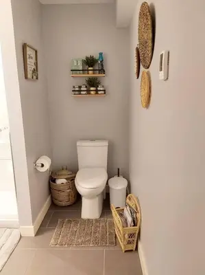 a bathroom with a toilet and baskets on the floor at Cozy suite, Free WIFI , Free Parking in Calgary